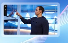 A person touching a glass screen