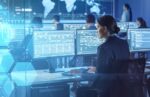 federal worker with multiple monitors in shades of blue